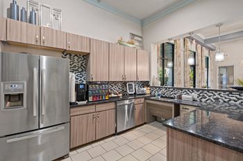 Clubhouse kitchen with a coffee bar including a convenient coffee machine.